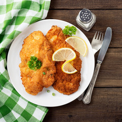 Homemade breaded german weiner schnitzel with potatoes. top view