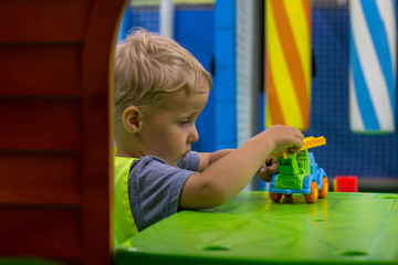 little child enthusiastically plays on the playground