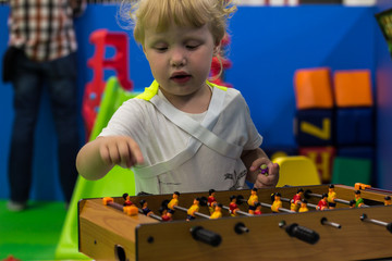 little child enthusiastically plays on the playground