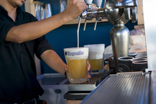 BANGKOK, THAILAND. September 12, 2018: Hoegaarden draft Belgium beer in large size glass on counter bar in pub was taken in Bangkok, Thailand.