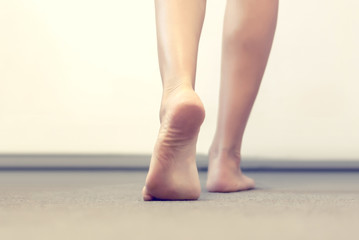 woman's legs go on a gray floor