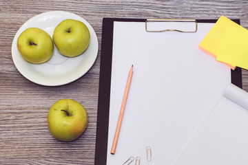An image of office accessories lying on wooden table.