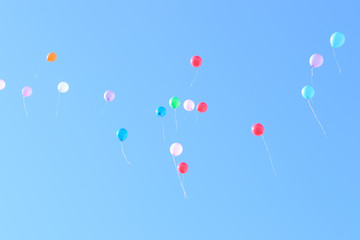Many colorful ballons in the blue and clear sky. Concept of celebration
