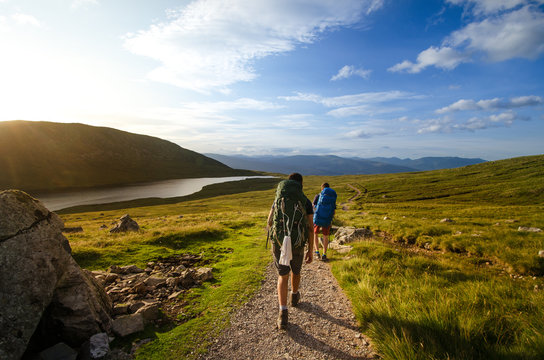 Tourist friends on a top of mountains in a Scottish Highlands. Scotland nature. Tourist people enjoy a moment in a nature.
 Tourists favourites place in Scotland - Isle of Skye.