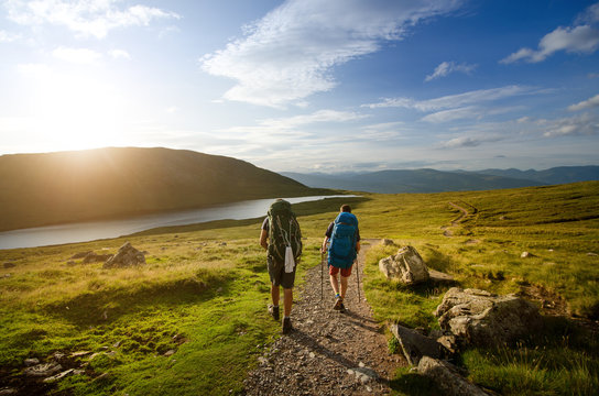 Tourist friends on a top of mountains in a Scottish Highlands. Scotland nature. Tourist people enjoy a moment in a nature.
 Tourists favourites place in Scotland - Isle of Skye.