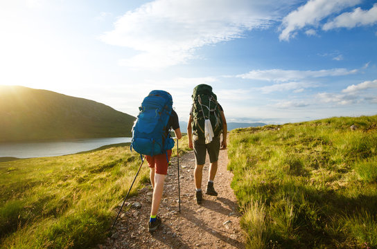 Tourist friends on a top of mountains in a Scottish Highlands. Scotland nature. Tourist people enjoy a moment in a nature.
 Tourists favourites place in Scotland - Isle of Skye.