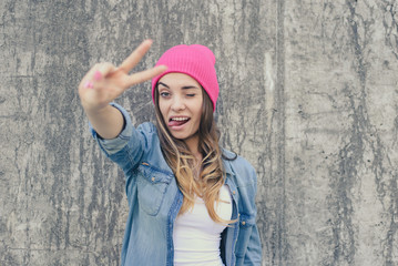 Self-confidence concept. Happy smiling winking and flirting woman dressed in casual clothes and...