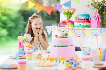 Kids birthday party. Child with cake and presents.