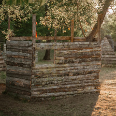 Wooden building shelter on polygon for playing lasertag game