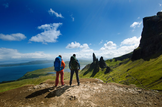 Tourist friends on a top of mountains in a Scottish Highlands. Scotland nature. Tourist people enjoy a moment in a nature.
 Tourists favourites place in Scotland - Isle of Skye.