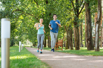 Useful activity. Joyful happy people moving forward while enjoying jogging in the morning