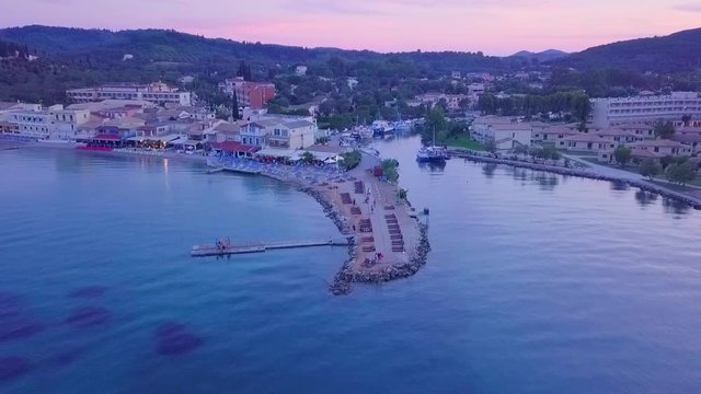 Greece, Corfu Island, drone footage of a beautiful sunset over Messonghi Beach.  Backwards Rise.