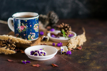 Herbal tea: pansies, petals, edible flowers, on a light background