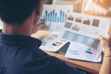Businessman review paper, annual report, summary report, document,graph in office. Financial adviser plan and working. Business and financial report concept.