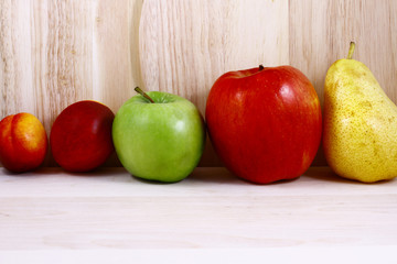 Beautifully laid out fresh summer fruits on a background of cutting boards