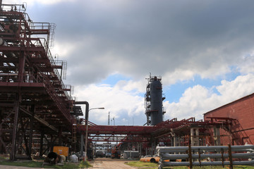 Fototapeta na wymiar Industrial landscape with pipes equipment and rectification columns at a chemical petrochemical refinery industrial refinery