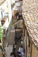 Old buildings, patio with stairs, a small Italian town.