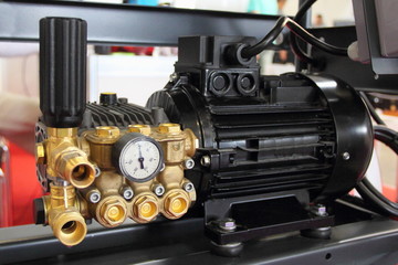 Equipment for automobile service - close up new electric high pressure pump with manometer for...