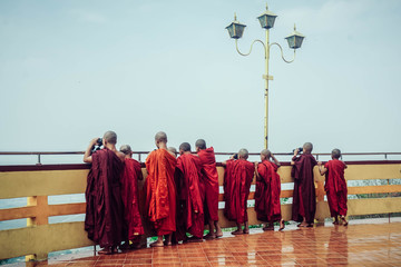 Buddhist monks look down on the city. Mandalay city, Myanmar