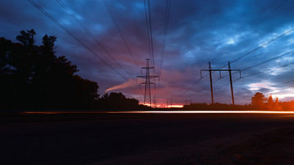 electric transmission line at night photo / hay from a passing car