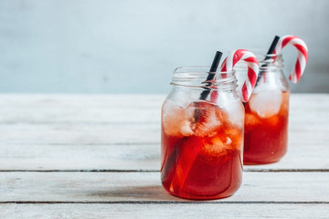 Red Christmas cocktail with candy cane. . Vintage toned