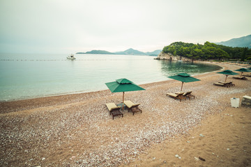 A beautiful Mediterranean beach with umbrellas and sun loungers