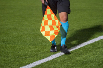 Assistant referee walking along the sideline during a soccer match