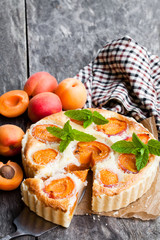 Homemade  cheese cake with apricot on wooden table