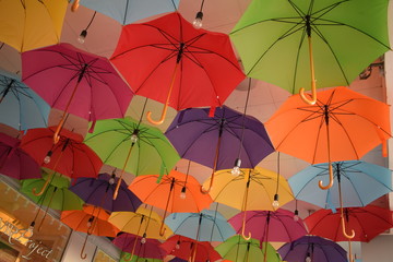 ceiling of a large number of colorful floating parasols