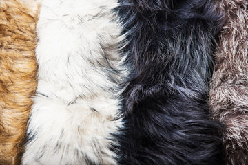 White and gray natural fur lies vertically close-up