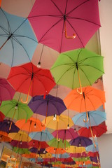 ceiling of a large number of colorful floating parasols