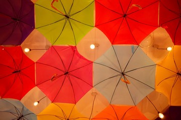 ceiling of a large number of colorful floating parasols