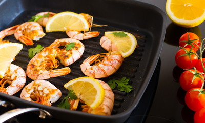 Food. Langoustines, induction stove, vegetables, grill pan