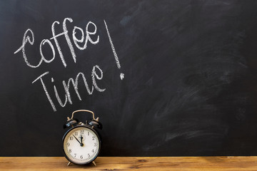 Alarm clock and text "coffee time" on the chalkboard.