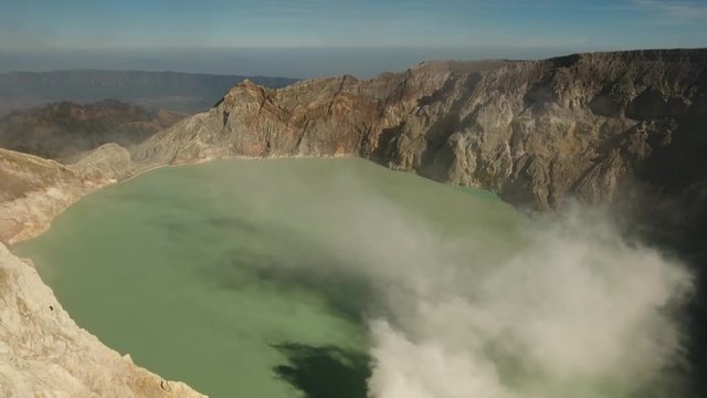 Crater with acidic crater lake Kawah Ijen the famous tourist attraction, where sulfur is mined. Aerial view of Ijen volcano complex is a group of stratovolcanoes in the Banyuwangi Regency of East Java