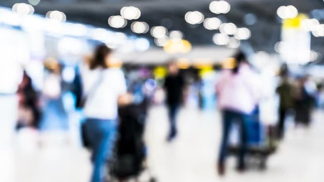 Time-lapse blur of passengers are walking in terminal of airport building located at Bangkok Thailand