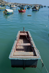 Traditional colorful boats in the Harbor of Mediterranean fishing village Marsaxlokk, Malta