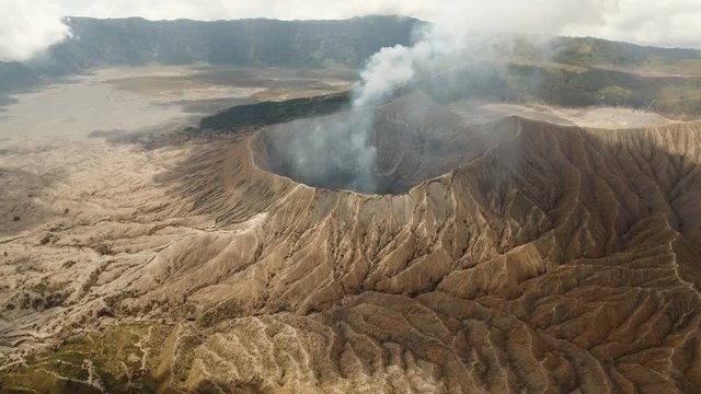 Mountain Bromo active volcano crater in East Jawa, Indonesia. Aerial view of volcano crater Mount Gunung Bromo is an active volcano,Tengger Semeru National Park. 4K video. Aerial footage.