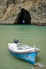 Fototapeta na wymiar Boat near cave on the sea in Malta