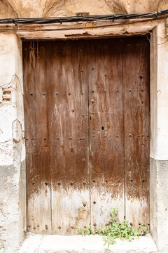 Old oak door with bronze round handles.