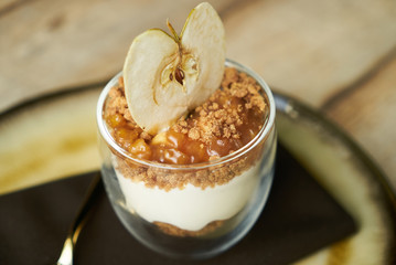 Dessert New york cheese cake with mousse with apple cream, caramel, muskovado, close-up. Healthy breakfast food