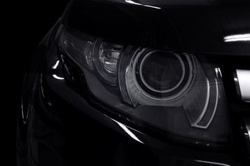 Black car headlights. Exterior detail. Transportation background.