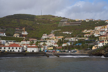 Fototapeta na wymiar Black stone beach in Câmara de Lobos, Madeira