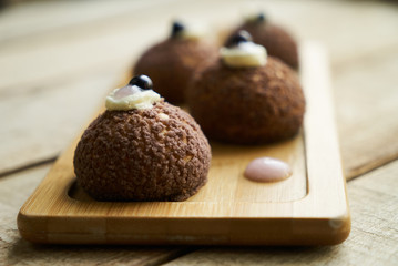 Cake Brioche shu cream chantilly, eclair. Sweet breakfast dessert. White chocolate profiteroles with peach violet.