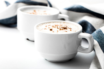 Cappuccino on a striped tablecloth. Morning coffee.