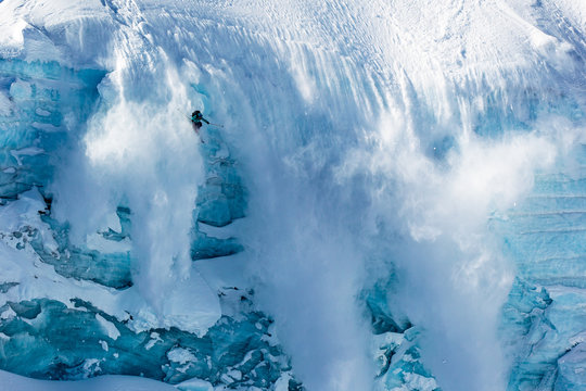 Skier skiing off of a mountain