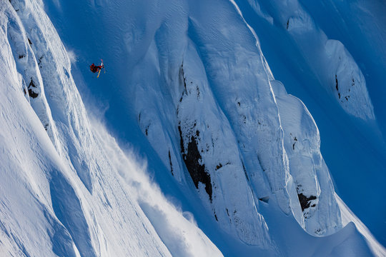 Skier skiing down a snowy mountain
