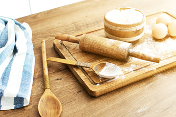 Female hands making dough on kitchen background