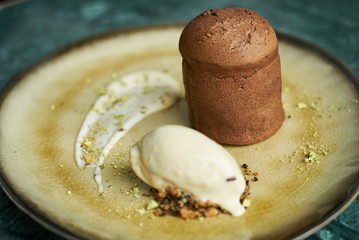 Fondant dessert and pistachio ice cream with English cream, pistachio crumble and sauce bailies