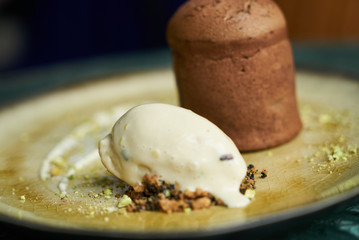 Fondant dessert and pistachio ice cream with English cream, pistachio crumble and sauce bailies